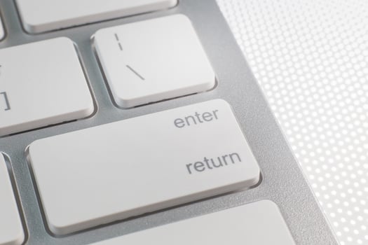 The enter silver modern keyboard close up image. photo