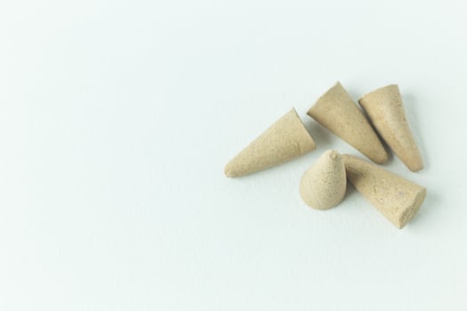 Incense Cone in a stand with the feather for background. photo