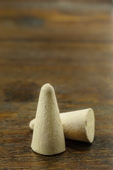 Incense Cone in a stand with the feather for background. photo