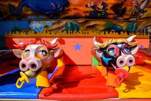 two cow heads on a carnival ride photo