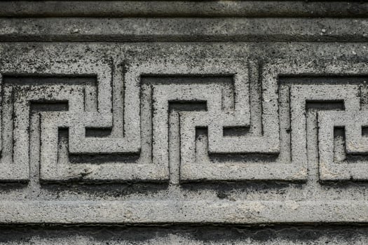a close up of a stone wall with a greek design photo