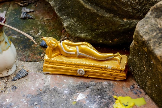 a golden statue of a woman laying down photo