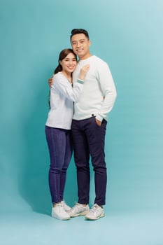 Image of happy young loving couple hugging isolated over blue background. photo