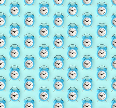 Wasting time concept. Many blue alarm clock photo