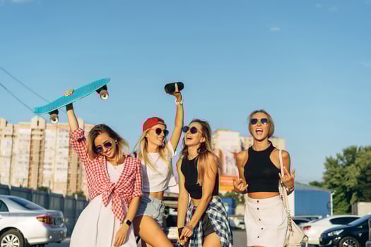 Four young girls have fun at the car park. photo