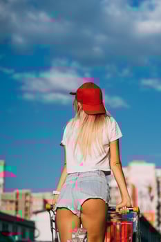 Young, sexy girl posing with a basket in a car park. photo