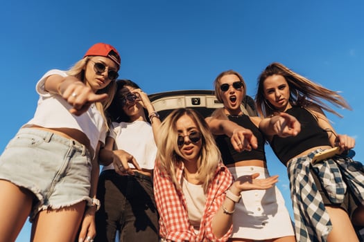 Five young woman looking in the camera the car park. photo