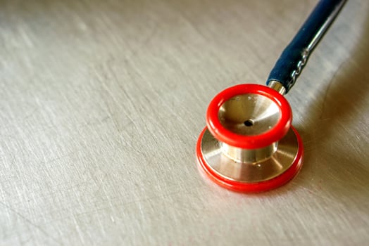 A small doctor stethoscope on aluminum board. photo