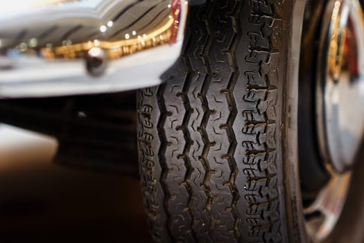 Vintage wheel with protector of retro car, closeup photo