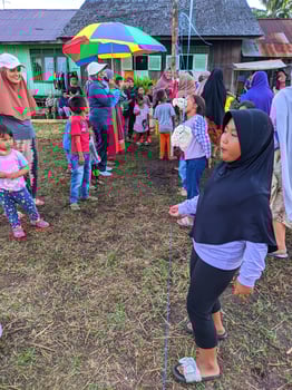 the excitement of adults and children taking part in a cracker eating competition to enliven the independence day of the republic of Indonesia, East Kalimantan, Indonesia August 13, 2022 photo