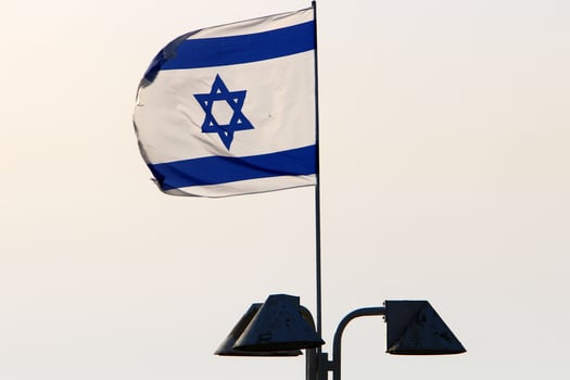 The blue and white Israeli flag with the Star of David. photo