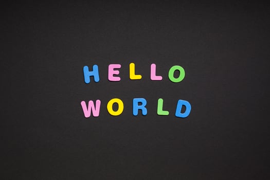 Hello world writing on black paper background photo
