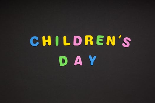 Children's day writing on black paper background photo
