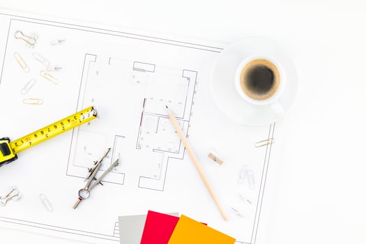Interior designer table workplace with house plan photo