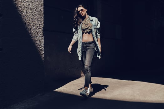 Beauty on the go. Full length of beautiful young woman walking down the street while spending time outdoors photo