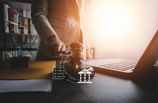 justice and law concept.Male judge in a courtroom on wooden table and Counselor or Male lawyer working in office. Legal law, advice and justice concept. photo