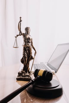 Business and lawyers discussing contract papers with brass scale on desk in office. Law, legal services, advice, justice and law concept picture with film grain effect photo