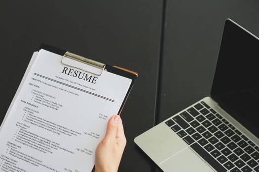 Close-up photo of a businesswoman holding resume