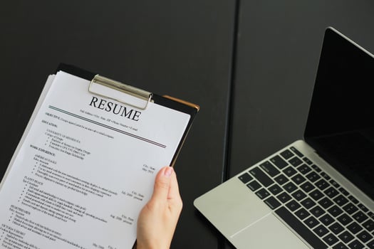 Close-up photo of a businesswoman holding resume
