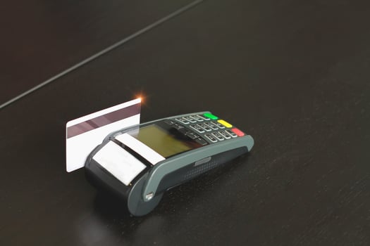 Credit card swipe machine for sell products in the shop. Concept of spending via credit card. photo