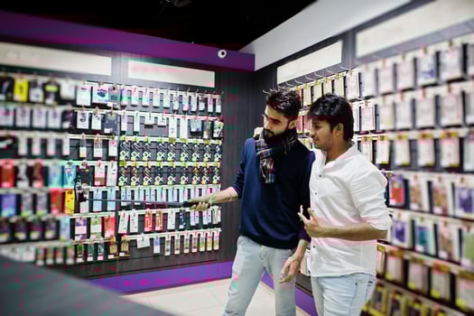 Two indians mans customer buyer at mobile phone making selfie by monopod stick. South asian peoples and technologies concept. Cellphone shop. photo