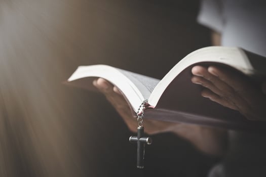 A woman holds Bible in his hands and studies the word of God.  Searching for truth in scriptures. praying for blessings of god. photo