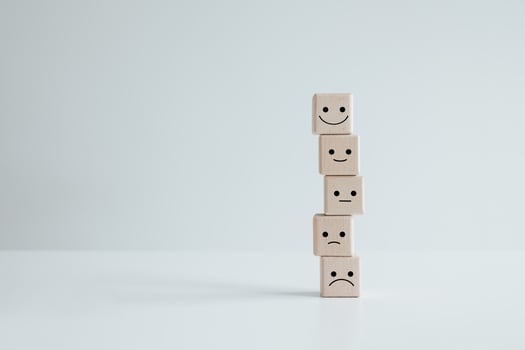 Customer service rating experience and feedback emotion and satisfaction survey concept. wood cube with smile, normal and sad face. Negative, neutral and positive facial expressions. photo