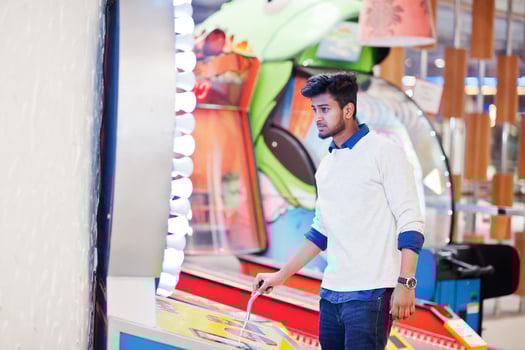 Young asian man play on fortune wheel slot machines to try win at lottery great prize. photo