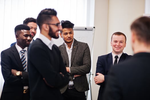 Male colleagues working in team cooperate , multiracial crew of employees concentrated on project planning against board and discussing ideas. photo