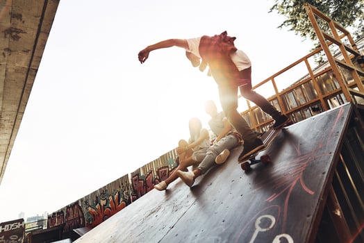 Born for boarding. Modern young men skateboarding while hanging out with his friends outdoors photo