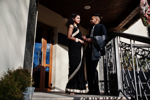 Lovely indian couple in love, wear at saree and elegant suit, posed outdoor terrace on summer sunny day. photo