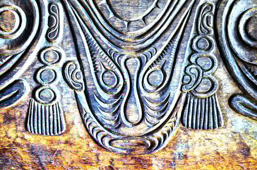 a close up of a carved wooden panel photo