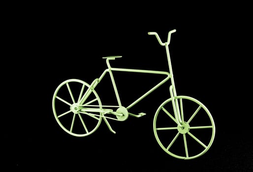 a green bicycle is shown against a black background photo