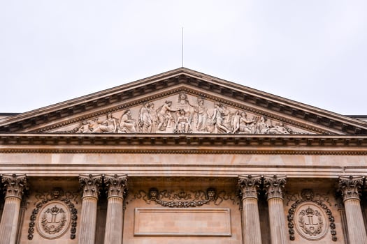the front of a building with statues on it photo