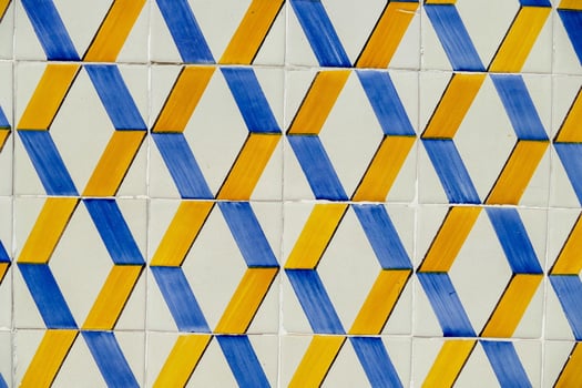 a blue and yellow tile wall with geometric shapes photo