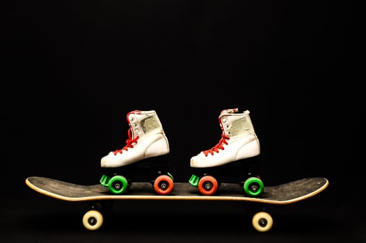 Skateboard and roller skates photo