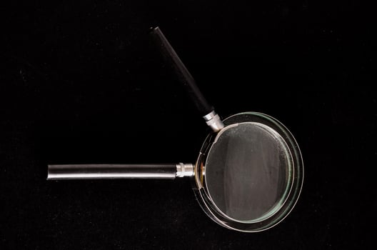 a magnifying glass on a black surface photo