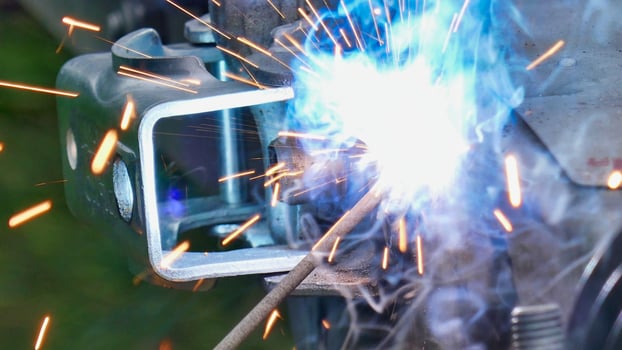 welder welding a metal object with sparks photo