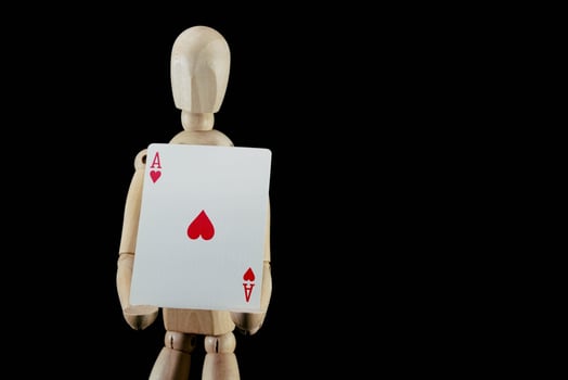 Wooden mannequin figurine on dark background photo