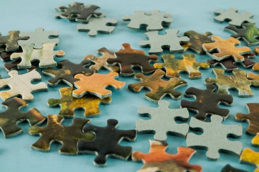 Puzzle pieces on light blue background photo