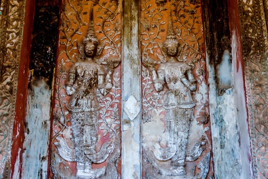 Buddhist reliefs on a temple door photo