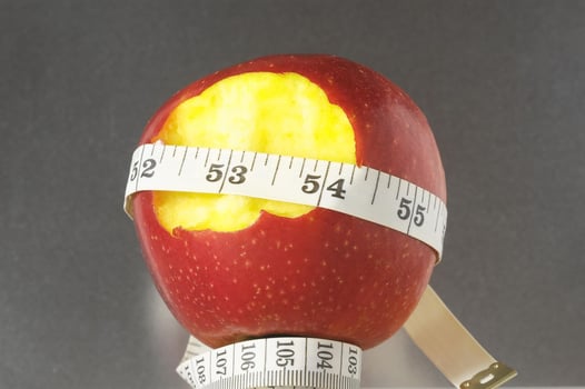 Apple with measuring tape photo