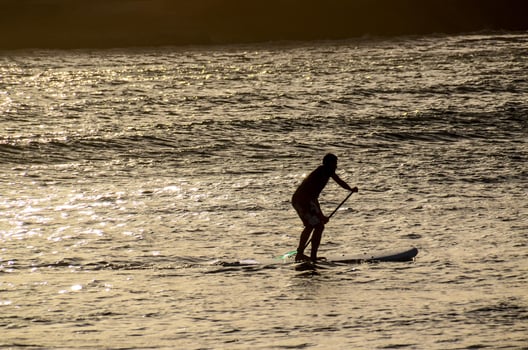 Silhouette of a person paddling photo