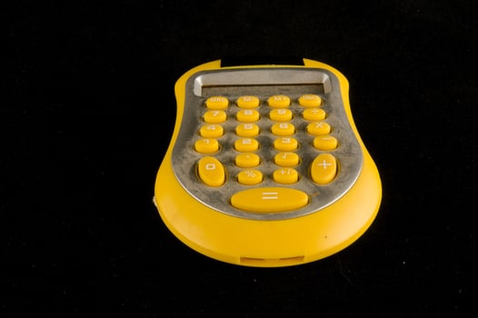 Yellow calculator on black photo