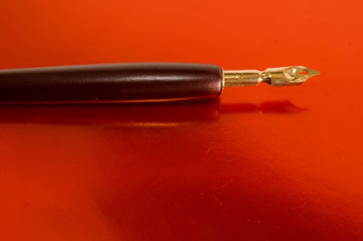 Fountain pen on red photo
