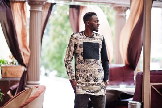 Handsome afro american man wearing traditional clothes in modern city. photo