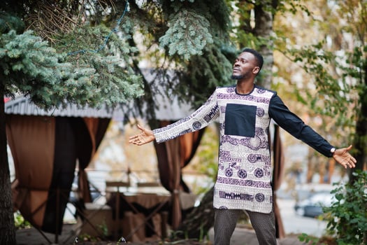 Handsome afro american man wearing traditional clothes in modern city. photo
