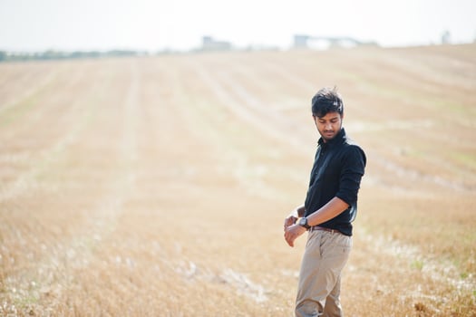 South asian agronomist farmer inspecting wheat field farm. Agriculture production concept. photo
