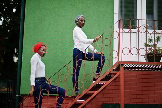 Two young modern fashionable, attractive, tall and slim african muslim womans in hijab or turban head scarf posed together. photo