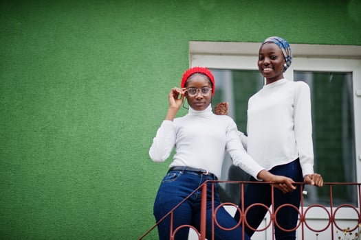 Two young modern fashionable, attractive, tall and slim african muslim womans in hijab or turban head scarf posed together. photo